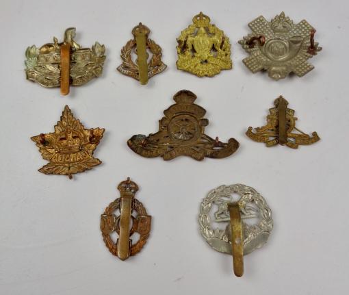 IMCS Militaria | 9 British and Canadian WW2 metal Cap Badges