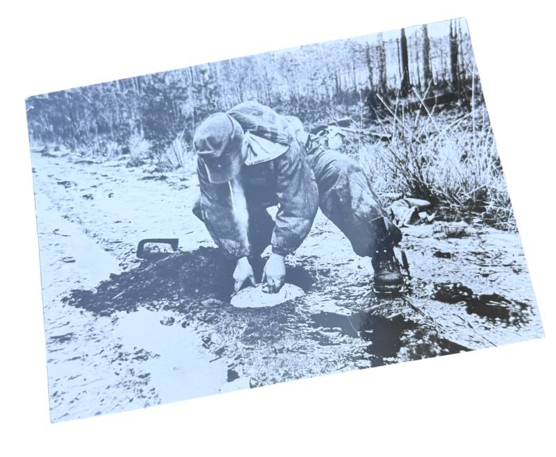 Very nice photograph of a Wehrmacht Soldier places an Anti Tank Mine